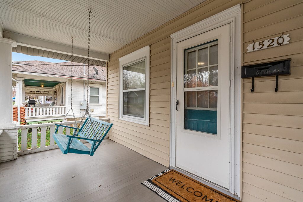 cairo st bungalow front porch blue swing welcome mat