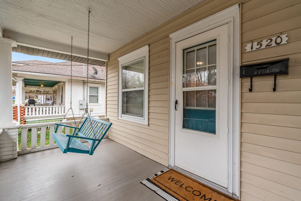 cairo st bungalow front porch blue swing welcome mat