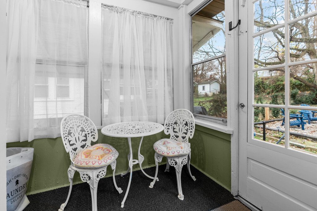 cairo st bungalow sunroom white bistro set backyard view